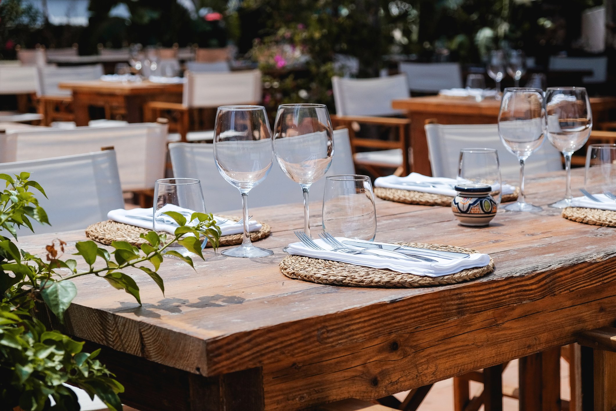 Close up view of glasses and silver ware set up on a table ready for guests to come and eat at Cobi's