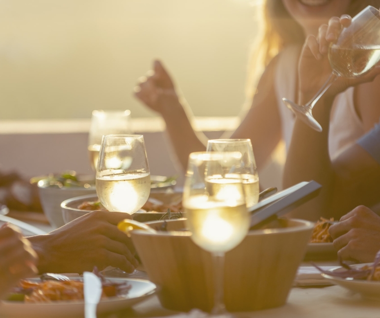 a group of people enjoying their dinner while eating outside