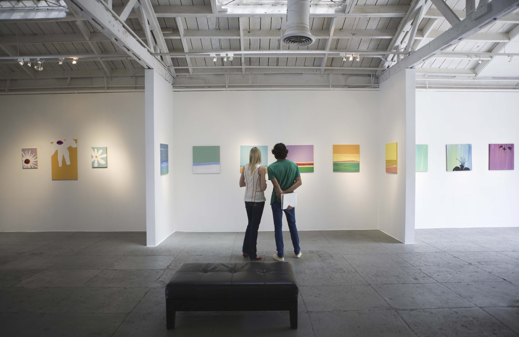 Two people checking out art on the wall at the Santa Monica Art Museum