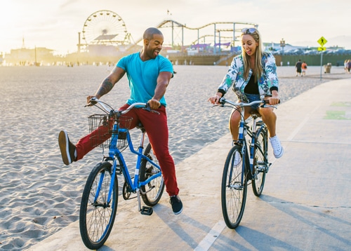 Couple riding bikes at Venice Beach