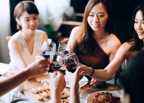 Women clinking wine glasses at Sandbourne Santa Monica
