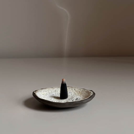 A black incense in a bowl