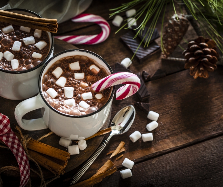 Close up view of cups of hot coco with marshmallows and candy canes at Sandbourne Santa Monica