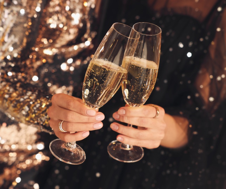 Woman clinking glasses of champagne at Sandbourne Santa Monica