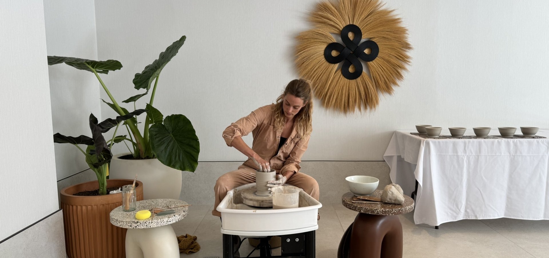 A person making art with clay in a ceramics class at Sandbourne Santa Monica