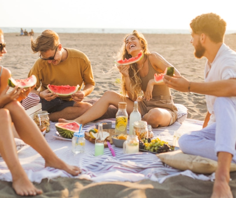 people eating a picnic on the beach