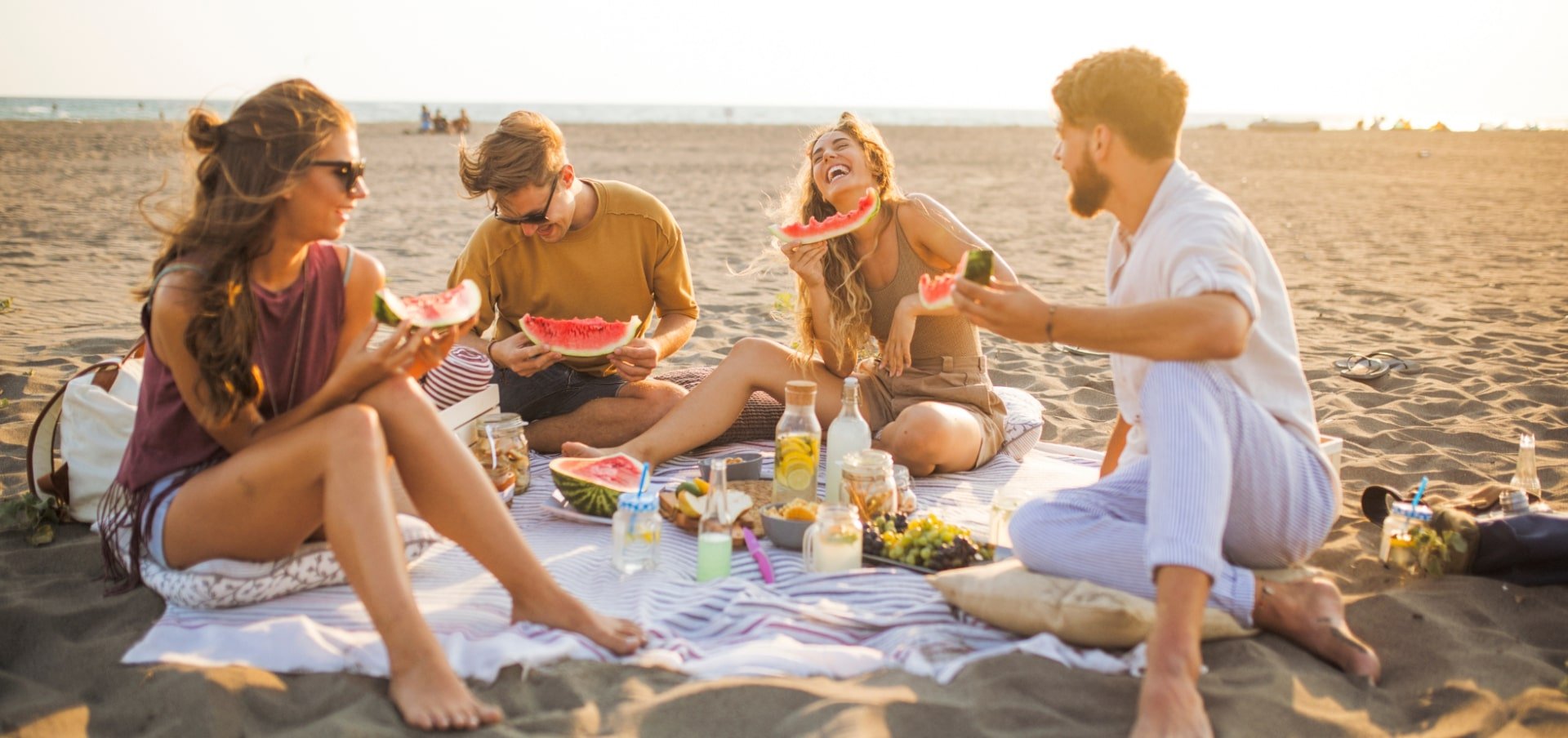 people eating a picnic on the beach