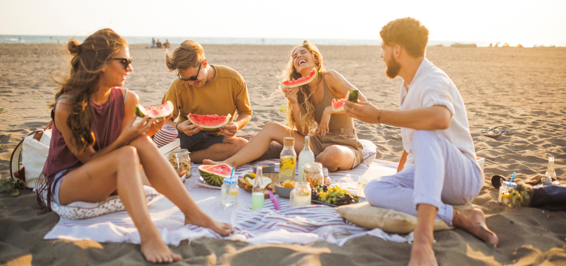 people eating a picnic on the beach